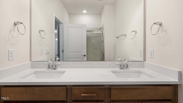 bathroom featuring an enclosed shower and vanity