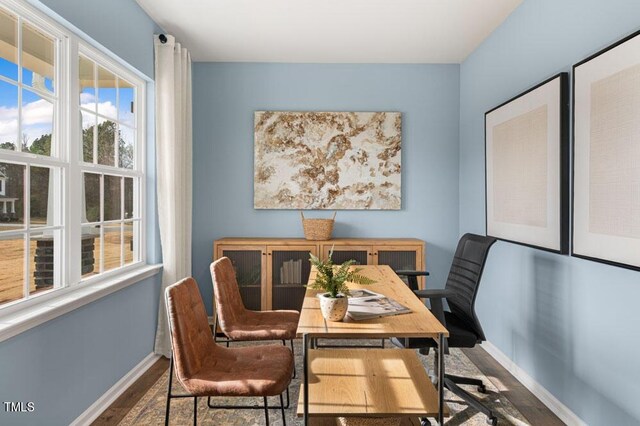 home office with hardwood / wood-style flooring