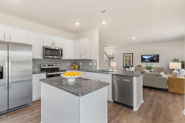 kitchen featuring dark hardwood / wood-style flooring, stainless steel appliances, sink, and white cabinetry