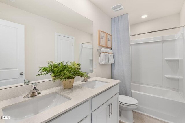 full bathroom featuring tile patterned flooring, vanity, toilet, and shower / bathing tub combination