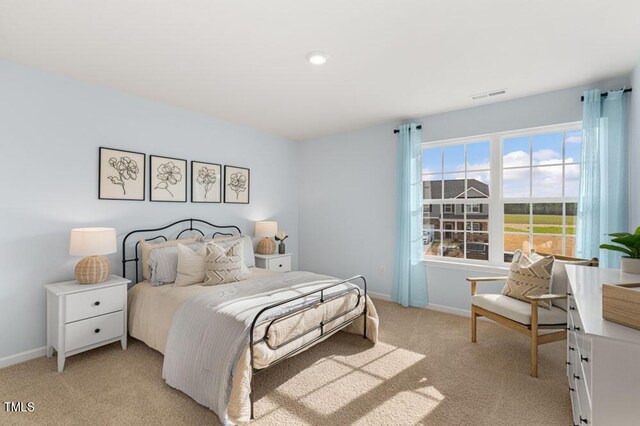 bedroom with light colored carpet