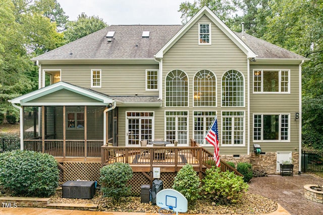 back of property featuring a sunroom, a patio area, and a deck