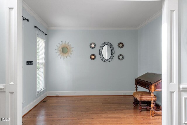 interior space featuring crown molding and hardwood / wood-style flooring