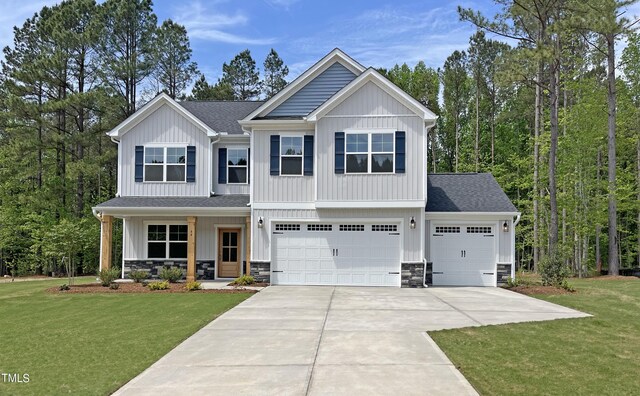 craftsman-style house with a front lawn, a garage, and covered porch