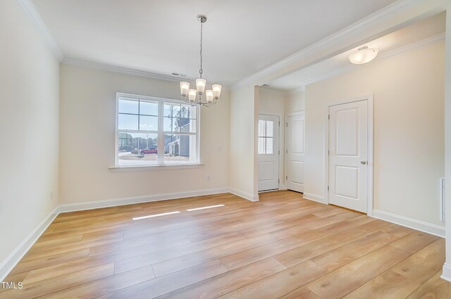 empty room featuring ornamental molding, a chandelier, and light hardwood / wood-style flooring