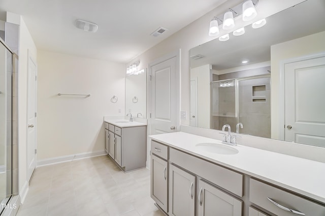 bathroom with tile patterned floors, walk in shower, and vanity