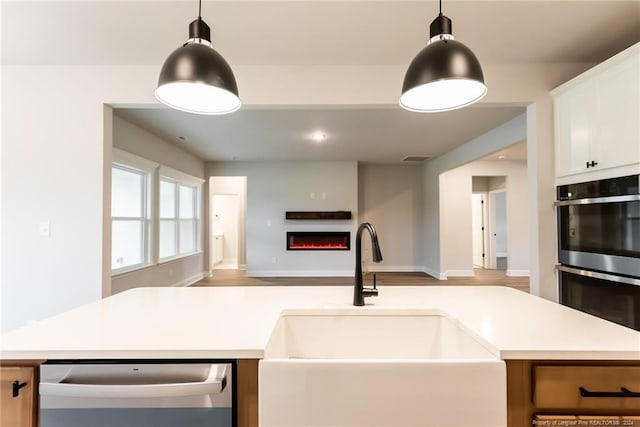 kitchen with white cabinets, a center island, sink, and stainless steel appliances