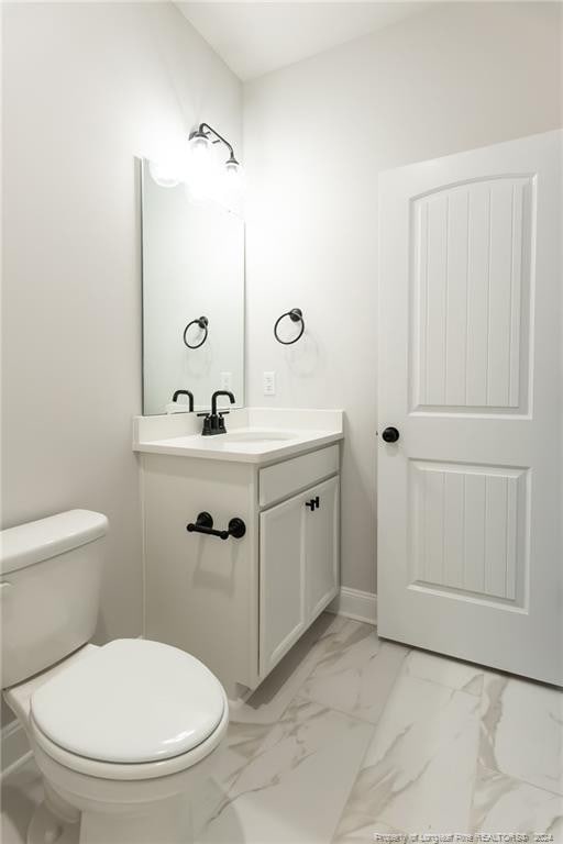 bathroom featuring vanity and toilet