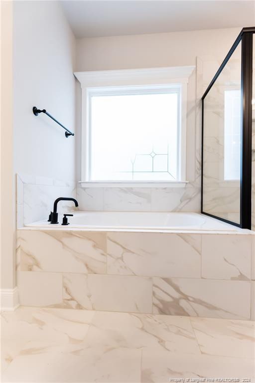 bathroom with tiled bath