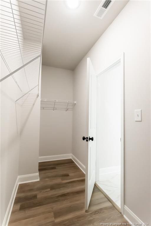 walk in closet featuring dark hardwood / wood-style floors