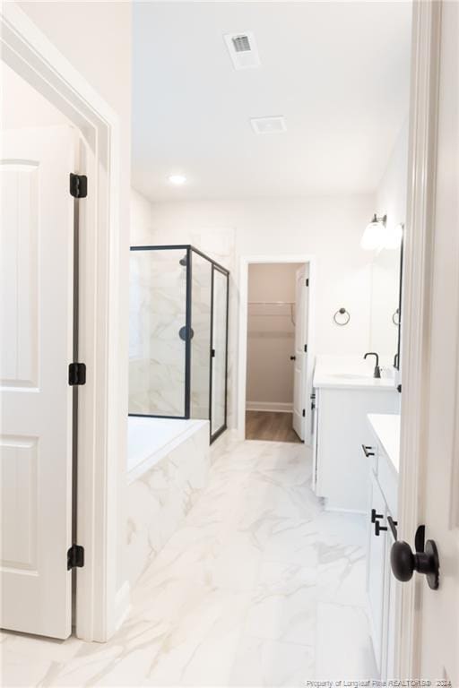 bathroom featuring vanity and a shower with shower door