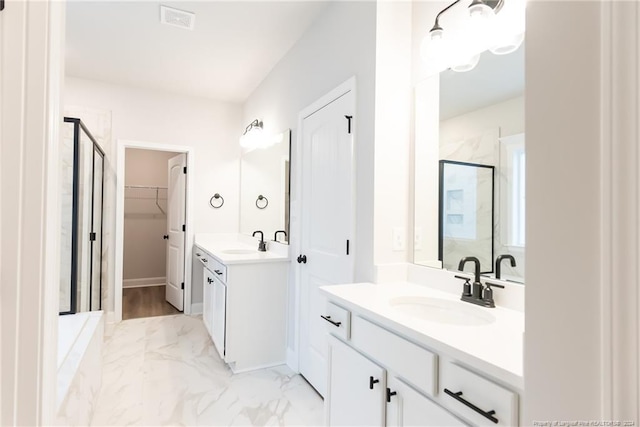 bathroom featuring vanity and a shower with door