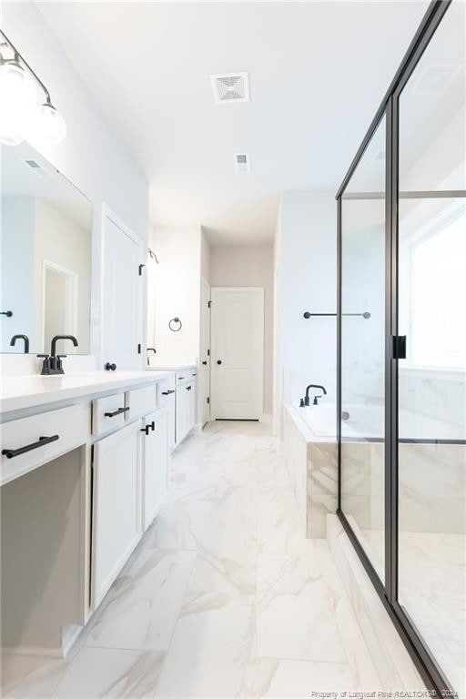 bathroom with vanity and separate shower and tub