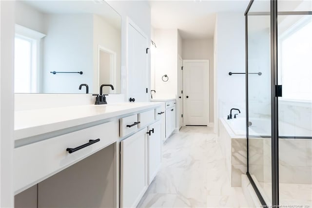 bathroom featuring vanity and separate shower and tub