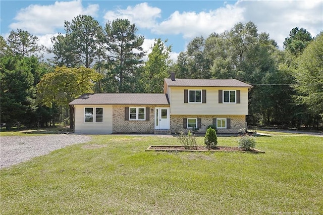 tri-level home featuring a front lawn