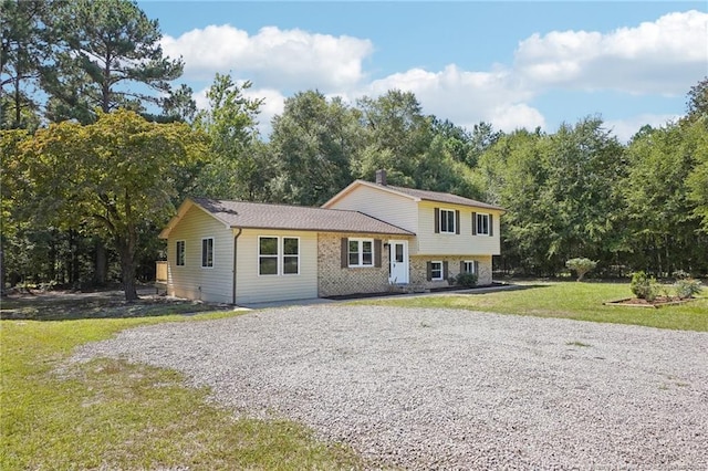 tri-level home featuring a front yard