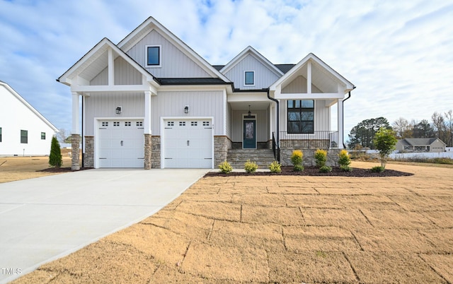 view of front of property with a garage, a porch, and a front lawn