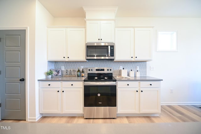 kitchen with white cabinetry, stainless steel appliances, light hardwood / wood-style floors, and tasteful backsplash