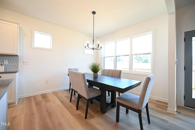 dining room with a notable chandelier and light hardwood / wood-style flooring