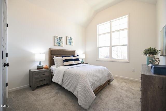 bedroom featuring vaulted ceiling and light carpet