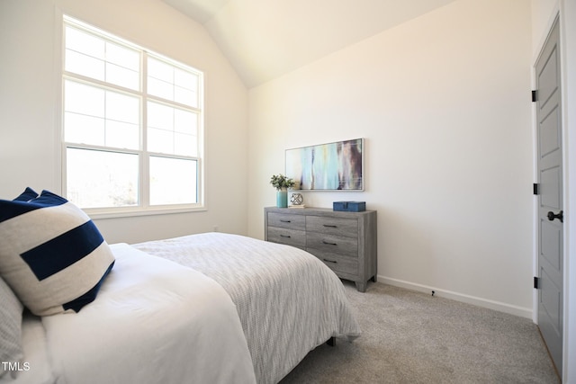 bedroom with lofted ceiling and light carpet