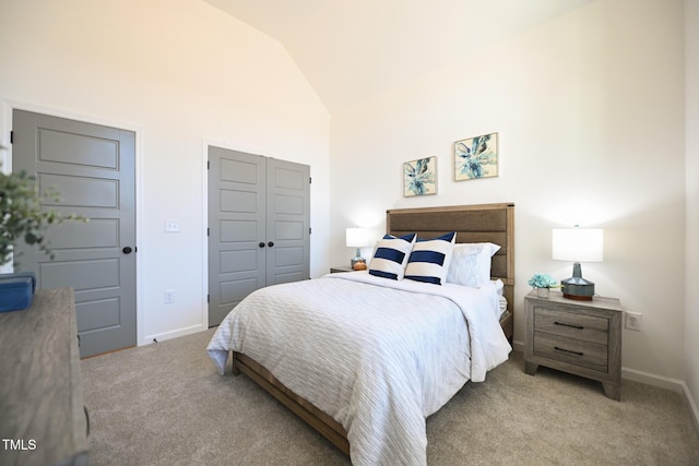 bedroom featuring a closet, high vaulted ceiling, and light carpet