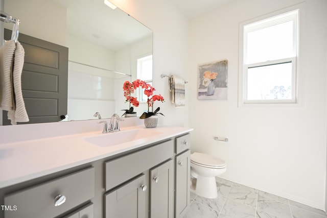 bathroom featuring vanity, a shower, and toilet