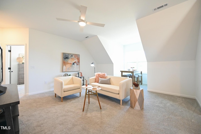 living room featuring ceiling fan, light colored carpet, and vaulted ceiling