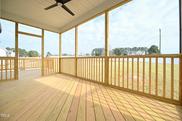 unfurnished sunroom featuring a wealth of natural light and ceiling fan