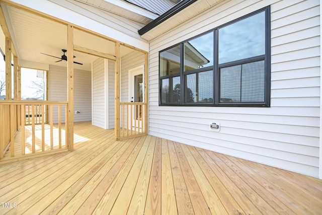 wooden terrace featuring ceiling fan