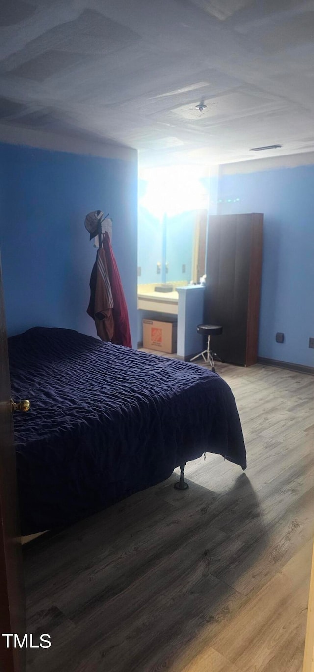 bedroom featuring wood-type flooring