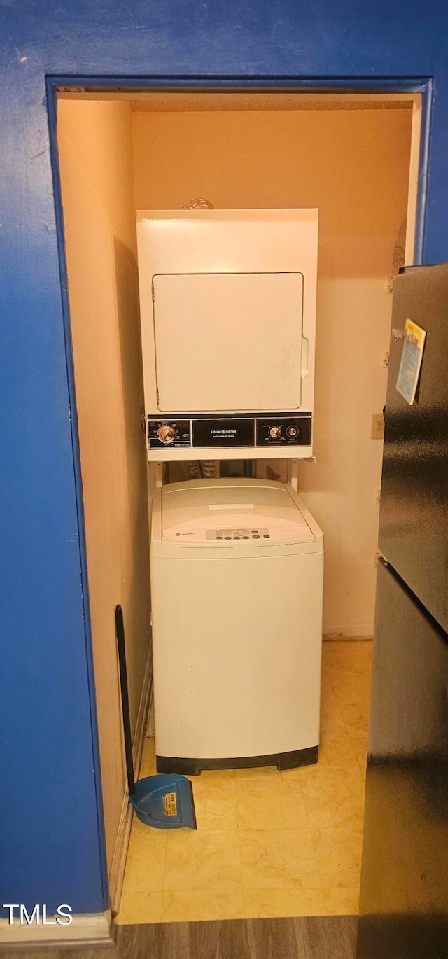 laundry room with stacked washer and dryer