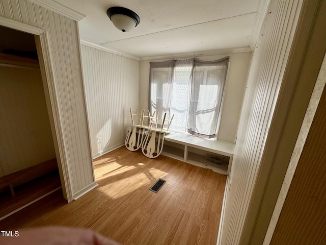 misc room featuring crown molding and light wood-type flooring