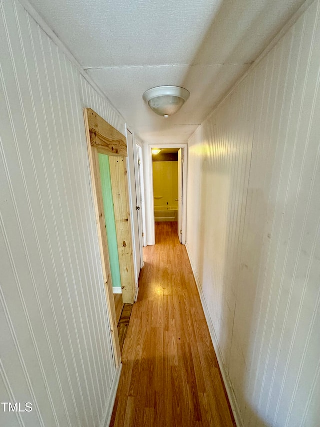 corridor with light hardwood / wood-style floors