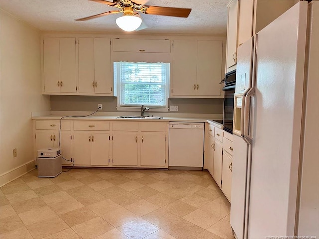 kitchen featuring white appliances, sink, white cabinetry, and ceiling fan