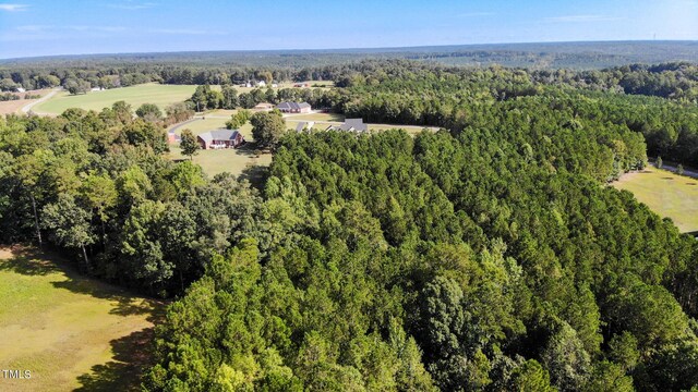 drone / aerial view featuring a view of trees