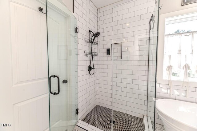bathroom featuring a freestanding bath and a stall shower