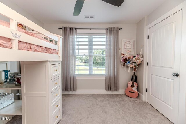 bedroom featuring ceiling fan, light colored carpet, and visible vents