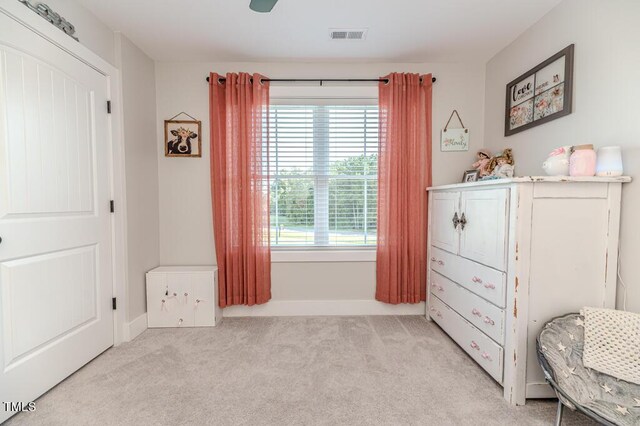bedroom with light carpet, baseboards, visible vents, and a ceiling fan