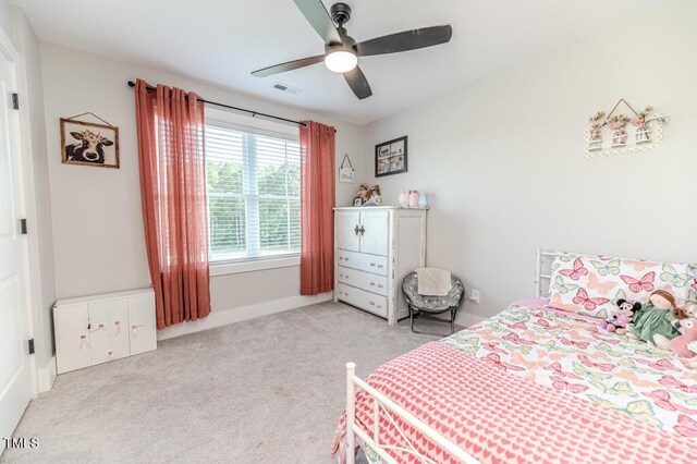 bedroom featuring baseboards, ceiling fan, visible vents, and light colored carpet