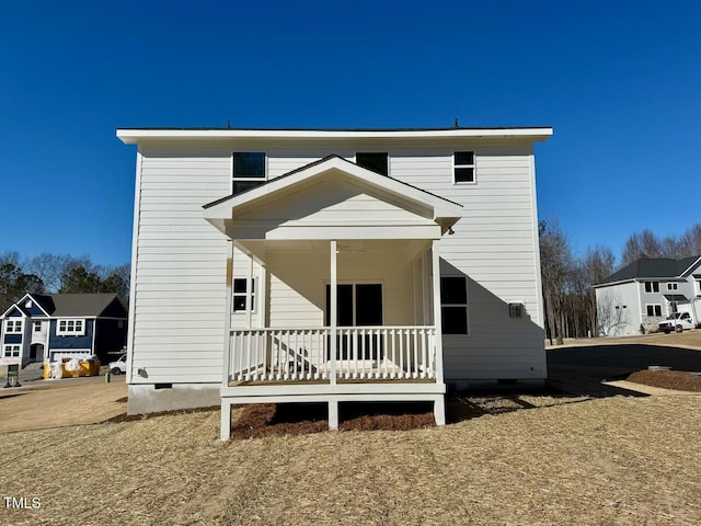 rear view of property with covered porch