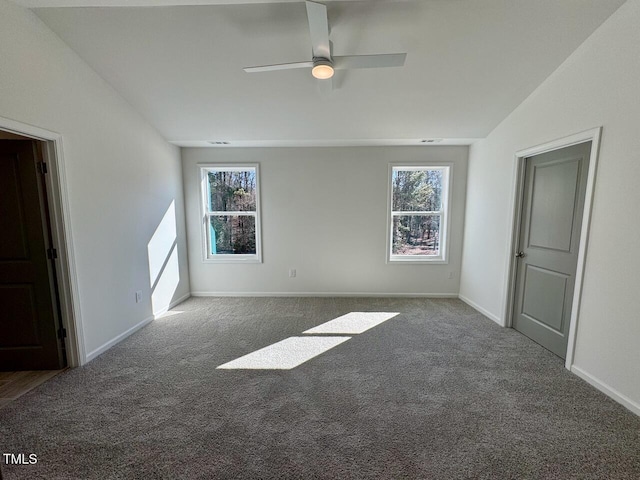 empty room with a ceiling fan, carpet, baseboards, and a wealth of natural light