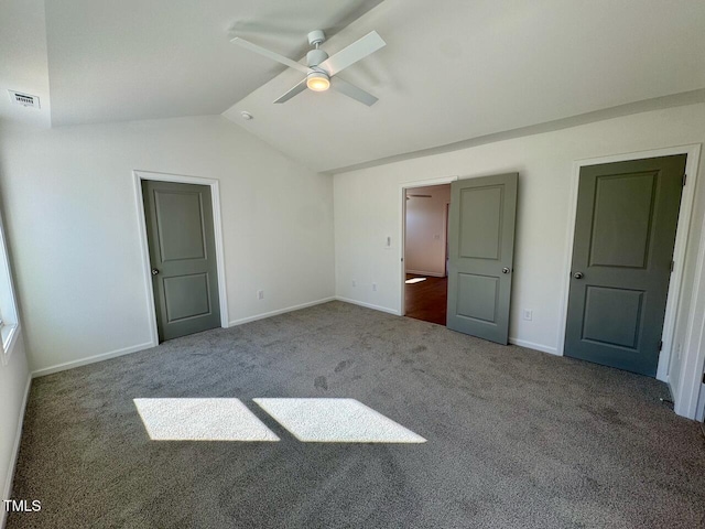 unfurnished bedroom with visible vents, baseboards, a ceiling fan, lofted ceiling, and carpet