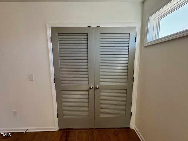 details featuring wood finished floors and baseboards