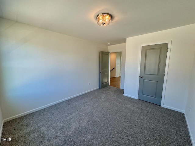 unfurnished bedroom with carpet flooring and baseboards