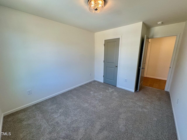 unfurnished bedroom with carpet and baseboards