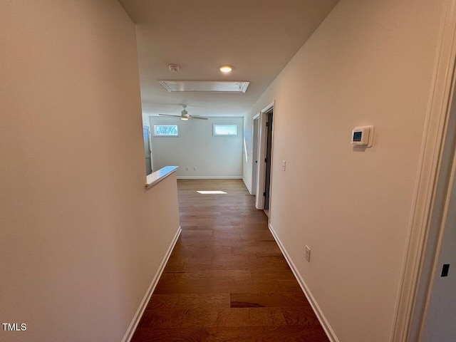 hall featuring dark wood finished floors and baseboards