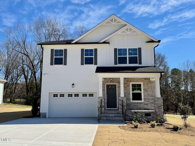 craftsman house featuring a porch, an attached garage, driveway, stone siding, and board and batten siding