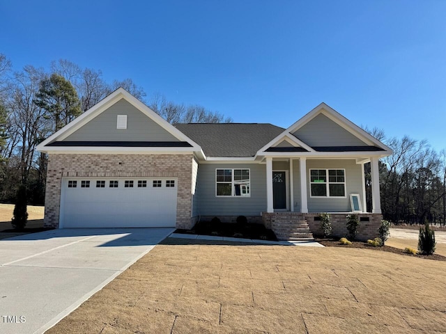 craftsman-style home with covered porch and a garage