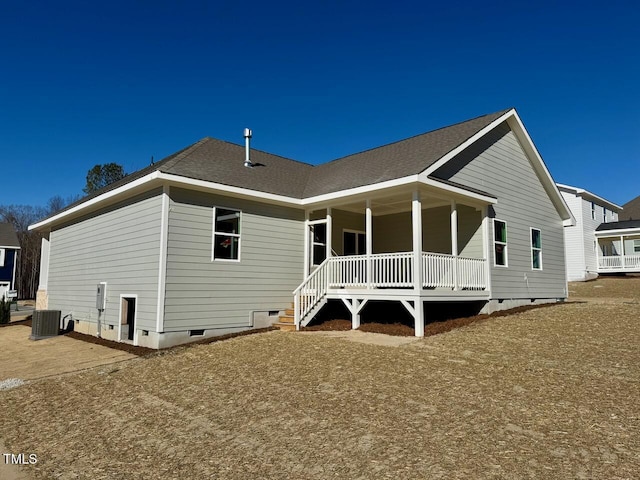 rear view of property with covered porch and central AC